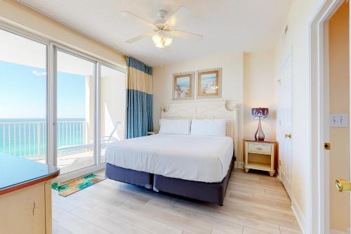 a bedroom with a bed and a large window at Ocean Villa 1706 in Panama City Beach