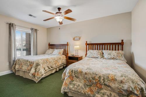 a bedroom with two beds and a ceiling fan at Bon Air 2011 in Gatlinburg