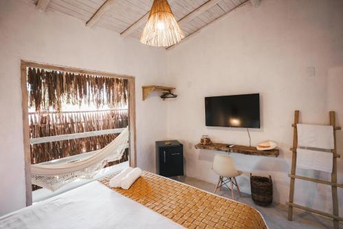 Een bed of bedden in een kamer bij Pousada Villa Cacau