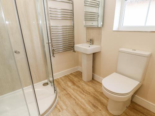 a bathroom with a toilet and a sink at Wansbeck in Longframlington