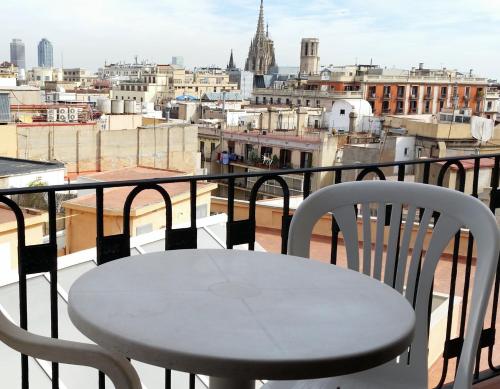 
a dining room with a balcony overlooking a city at Hostal Capitol Ramblas in Barcelona
