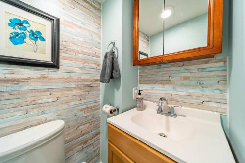 a bathroom with a sink and a mirror at Cheerful 3 BR. 2 Bath, Spacious Family Home in Akron