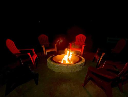 a group of chairs around a fire pit in the dark at NEW! The Grand Getaway at Williams - Family Friendly & Walk to the GC Train in Williams
