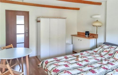 a bedroom with a bed and a table and a table at 1 Bedroom Nice Apartment In Smoldzino in Smołdzino