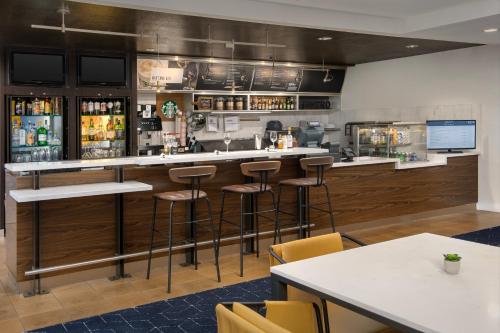 a bar in a restaurant with bar stools at Courtyard by Marriott San Diego Carlsbad in Carlsbad