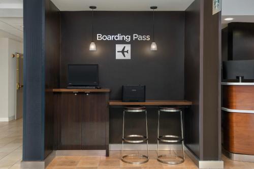 a bar with two stools and a sign that reads boarding pass at Courtyard by Marriott San Diego Carlsbad in Carlsbad