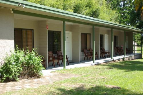 a porch of a house with chairs and trees at The Bushranger Hideaway in Midginbil