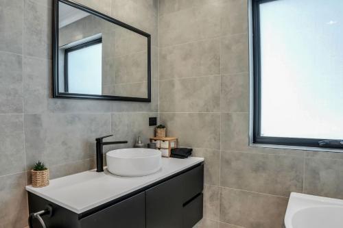 a bathroom with a sink and a mirror at Bridport by the Sea in Bridport
