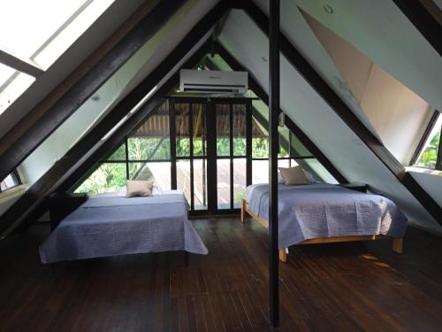 a bedroom with two beds in a attic at Amazon Lodge Varillal in Iquitos