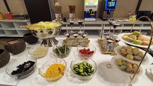 a table topped with bowls of different types of food at Hotel Leisure Tamsui in Tamsui