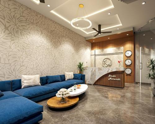 a living room with a blue couch and a table at Trimrooms Shubharambh Ayodhya in Ayodhya