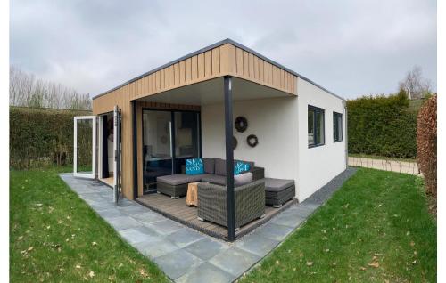 a small shed with a couch and a patio at 2 Bedroom Lovely Home In Heinkenszand in Heinkensand