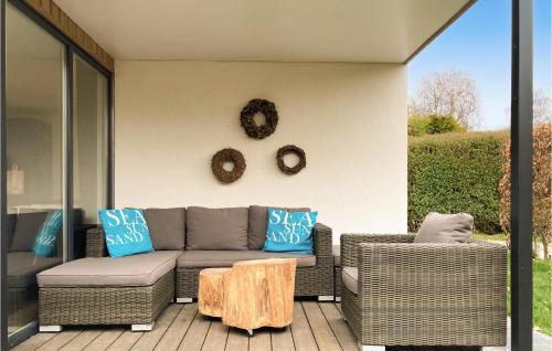 a patio with a couch and two chairs and a table at 2 Bedroom Lovely Home In Heinkenszand in Heinkensand