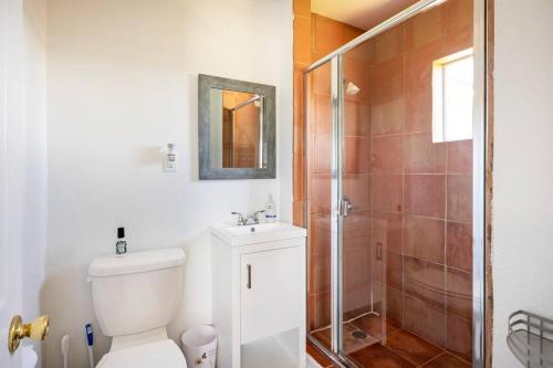 uma casa de banho com um chuveiro, um WC e um lavatório. em Misha’s Hunn Cottage em Yuba City