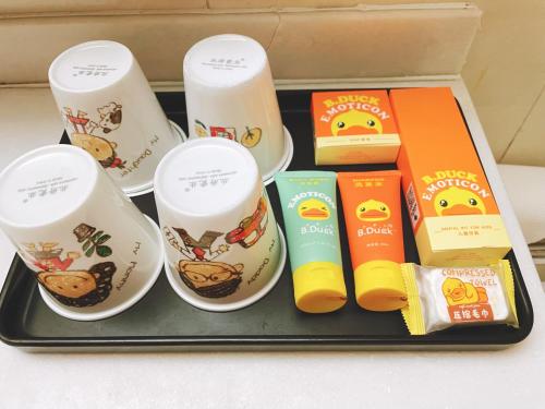 a tray with a box of breakfast food and books at King Parkview Hotel in Beijing