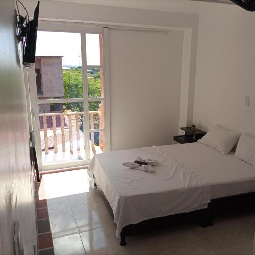 a bedroom with a bed and a large window at BONANZA in Monterrey