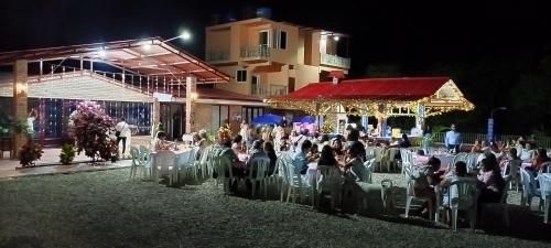 a crowd of people sitting in chairs at an event at night at BONANZA in Monterrey