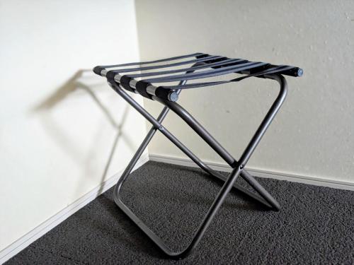 a black and white stool sitting next to a wall at SOKI Kanazawa in Kanazawa