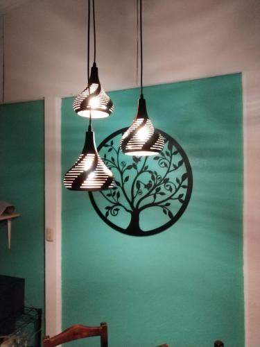 a couple of lights hanging from a wall at Villa Gabriela, Casa Tucan in Liberia