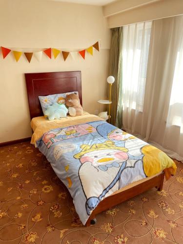a bedroom with a bed with two teddy bears on it at King Parkview Hotel in Beijing