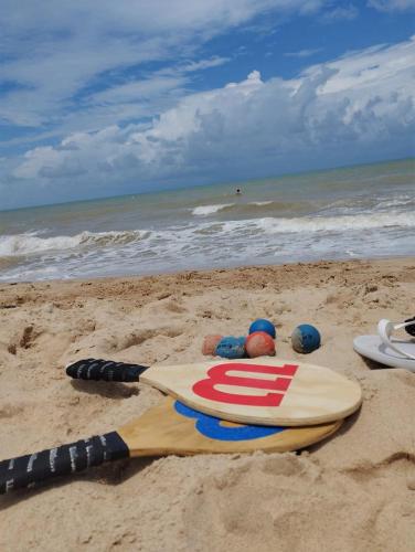 a surfboard laying on the sand on the beach at A Oca Hostel in João Pessoa