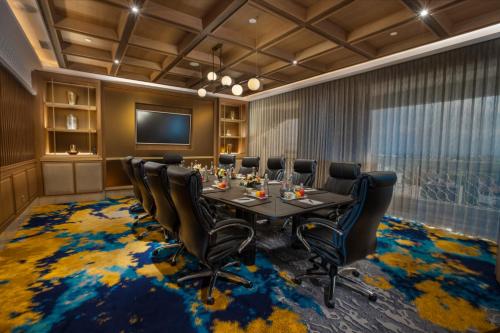 a conference room with a table and chairs at Royal Ambarrukmo Yogyakarta in Yogyakarta