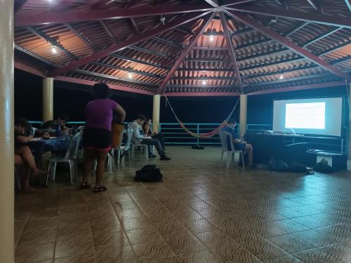 a group of people sitting in a room with a presentation at Rancho Juancho in Portobelo
