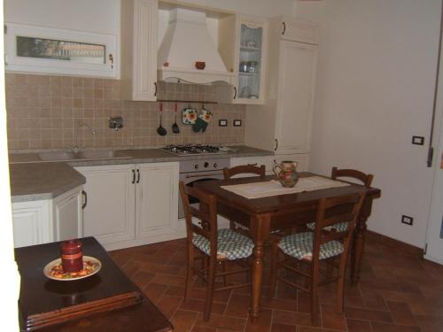 a kitchen with a table and some chairs and a counter at Bel Sit in Bologna