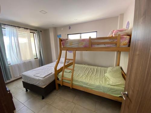 two bunk beds in a small room with a window at Departamento Playas Villamil vacaciones in Playas