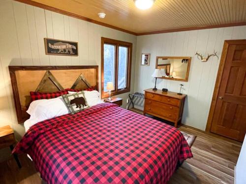 a bedroom with a bed and a dresser and a mirror at Pet friendly cabin on 5 Acres near Boone & parkway in Triplett