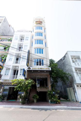 a tall white building with a sign on it at Queen Garden Hotel & Apartment in Vung Tau