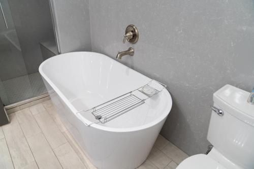 a bathroom with a toilet with a towel rack on the lid at Tyler Inn at Zion in Rockville