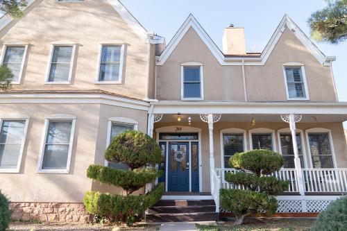 a house with a blue door and trees in front at Tyler Inn at Zion in Rockville