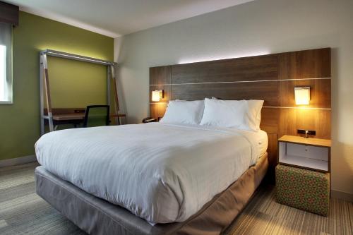 a hotel room with a large bed and a desk at Holiday Inn Express & Suites Wapakoneta by IHG in Wapakoneta
