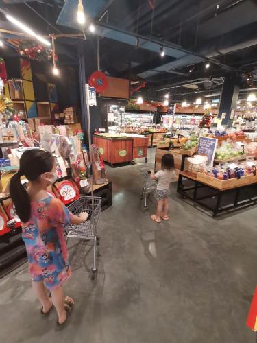two children are standing in a grocery store aisle at Opposite Legoland 5mins Medini DPristine 8 to 10pax in Nusajaya