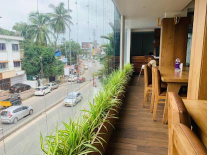 a balcony with a table and a view of a street at Hotel Omkara in Kozhikode