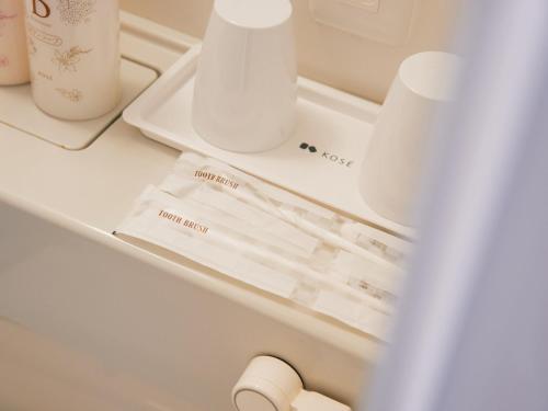 a white drawer with some items on it at Hotel -ASIATO- in Osaka