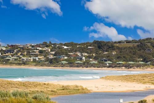 a view of a beach with houses in the background at Bella Vista in Apollo Bay