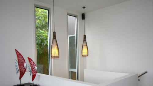 a white room with two lights and a mirror at The Lane House in Apollo Bay
