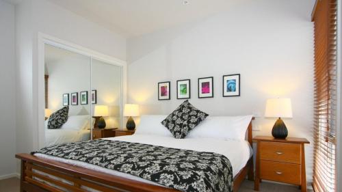 a bedroom with a bed and a mirror at The Lane House in Apollo Bay
