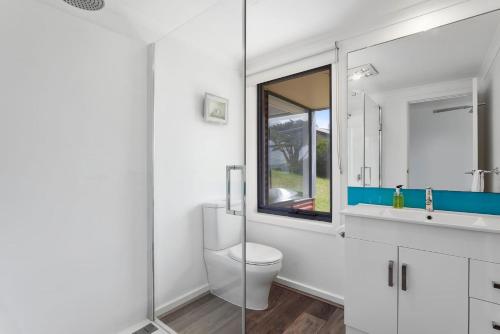 a bathroom with a toilet and a sink and a mirror at Blue Sea in Apollo Bay