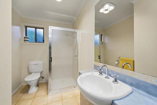 a bathroom with a toilet and a sink and a shower at The Boulevard in Lorne