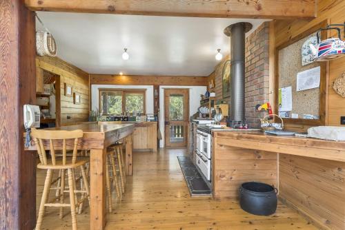 a kitchen with wooden walls and wooden flooring at Walshan House in Apollo Bay