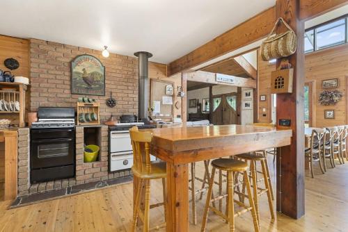 a kitchen with a wooden counter and a brick wall at Walshan House in Apollo Bay