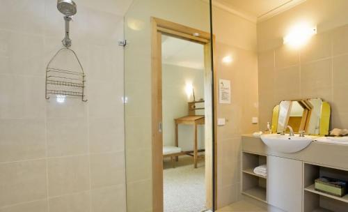 a bathroom with a shower and a sink and a mirror at 2 Degrees of Separation in Wye River