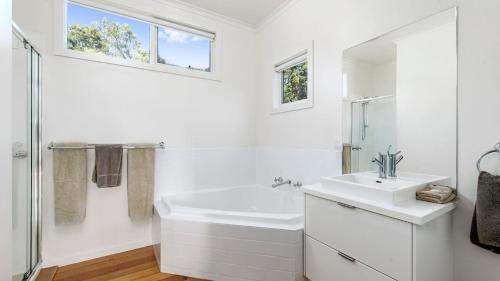 a white bathroom with a sink and a shower at Joanna in Johanna