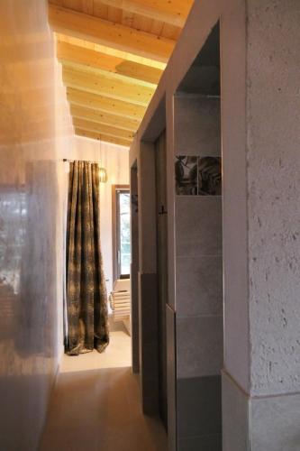 a hallway with a door to a room with a curtain at Sibenbras Natural Aparthotel in Limone sul Garda