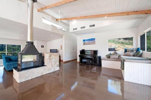 a living room with a fireplace and a couch at Eagle Ridge in Hordern Vale