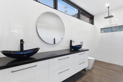 a bathroom with a blue sink and a mirror at Phoenix on Wye in Wye River