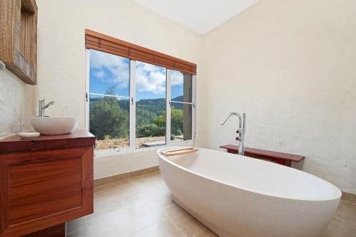 a large white bath tub in a bathroom with a window at Eagle Ridge in Hordern Vale